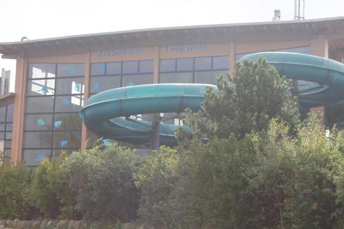 a water slide in front of a building at Aparthotel Leuchtfeuer Rügen in Glowe