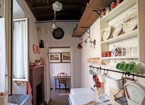 a room with a kitchen with plates on the wall at BIANCOFIORE Alloggio Turistico in Capodimonte