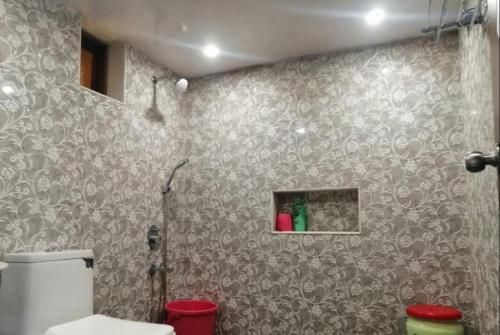 a bathroom with a shower and a toilet in it at West Vally Villa - Casa West in Panchgani