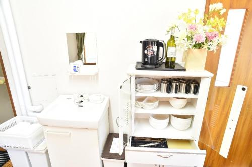 a white kitchen shelving unit with a coffee maker at Greenheim Suitengushita / Vacation STAY 252 in Otaru