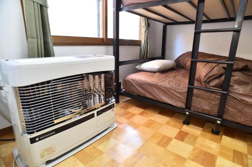 a room with two bunk beds with a air conditioner at Greenheim Suitengushita / Vacation STAY 252 in Otaru