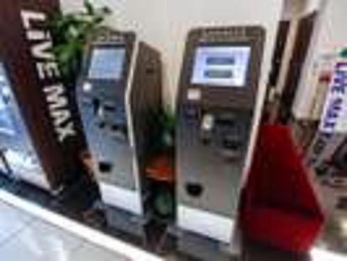 two atm machines on a shelf in a store at HOTEL LiVEMAX Nigata Nagaoka Station in Nagaoka