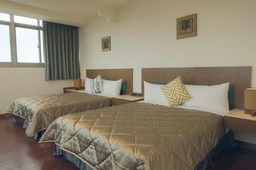Postel nebo postele na pokoji v ubytování SongHo Hotel