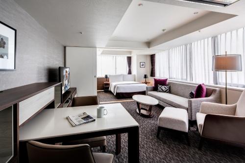 a hotel room with a bed and a living room at Somerset Ginza East Tokyo in Tokyo