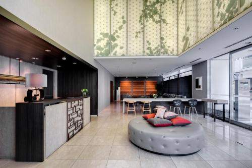 a kitchen and living room with a circular ottoman at Somerset Ginza East Tokyo in Tokyo
