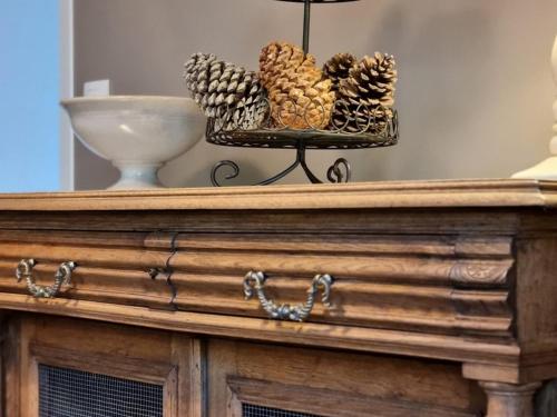 a table with a tray of pine cones on it at Gîte tout inclus avec jardin clos, terrasse privative, proche forêt et randonnées, 1 chambre, 1 canapé-lit - FR-1-510-168 in Preux-au-Bois