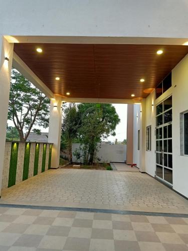 an empty patio of a building with a wooden ceiling at Sun Stone Hotel & Club - Jawai in Sheoganj