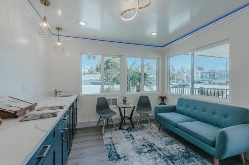 a living room with a blue couch and a table at Sea Air Inn & Suites - Downtown - Restaurant Row in Morro Bay