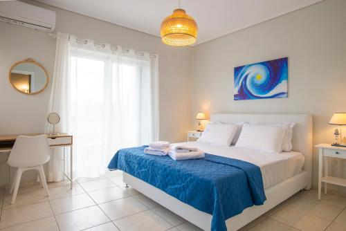 a bedroom with a bed with towels on it at Kima: Relaxing beach home next to sparkling waters in Nea Makri