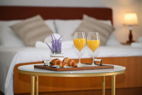a tray with two wine glasses and croissants on a table at Beach House Poseydon in Mlini