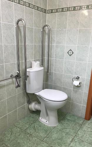 a bathroom with a toilet in a tiled wall at Hotel Karolina in Karlovy Vary