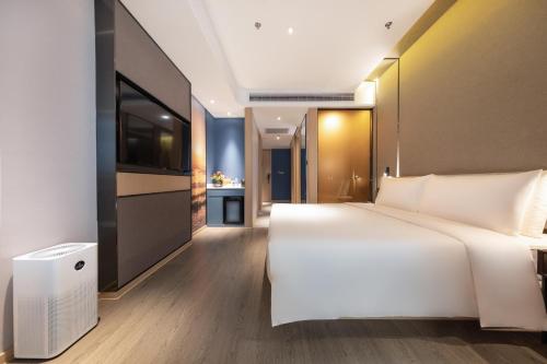 Ένα ή περισσότερα κρεβάτια σε δωμάτιο στο Atour Hotel Kunming Economic Development Zone