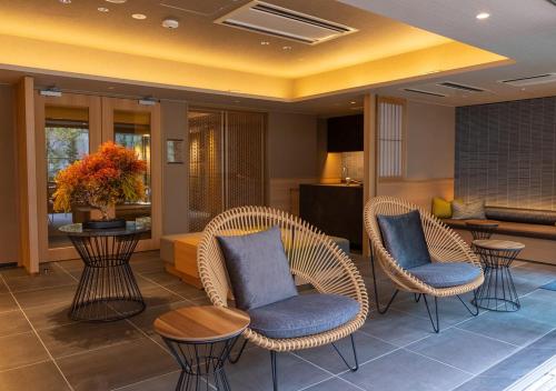 a room with a table, chairs, and tables at Hotel Niwa Tokyo in Tokyo