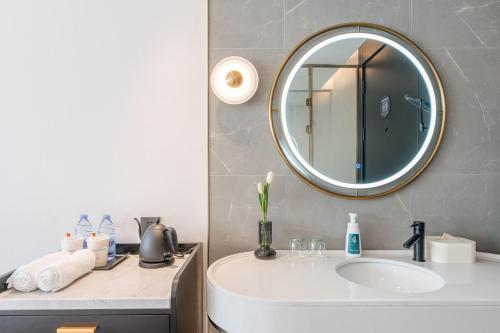 a bathroom with a sink and a mirror at Atour X Hotel Renmin Bridge South Metro Panmen Scenic Area Suzhou in Suzhou