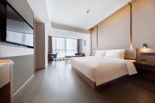 Ένα ή περισσότερα κρεβάτια σε δωμάτιο στο Atour Hotel Changde Laoximen