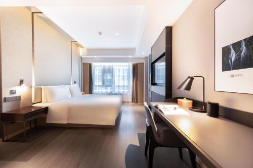 a hotel room with a bed and a desk at Atour Hotel Guiyang Guanshan Lake City Government in Guiyang