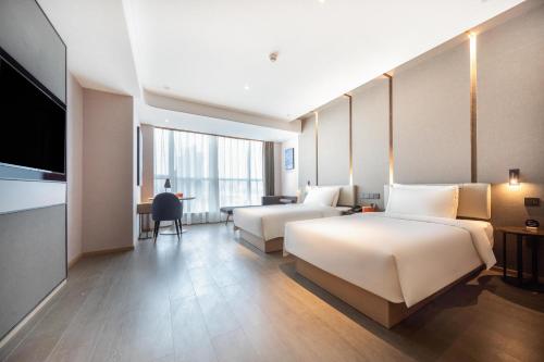 Ένα ή περισσότερα κρεβάτια σε δωμάτιο στο Atour Hotel Changde Laoximen