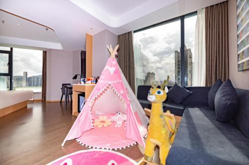a living room with a pink play tent at Atour Hotel Zhuhai Gongbei Fuhuali in Zhuhai