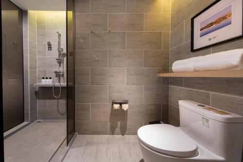 a bathroom with a toilet and a shower at Atour Hotel Nanchang Red Valley Beach Causeway Bay in Nanchang