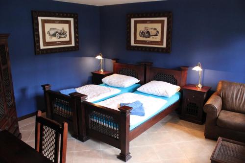 a bedroom with two twin beds and a couch at Penzion U Veterána in Slatinice