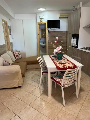 a living room with a table and two chairs at Baglio Cracchiolo da Tuzzo - Casa Il Limone in San Vito lo Capo