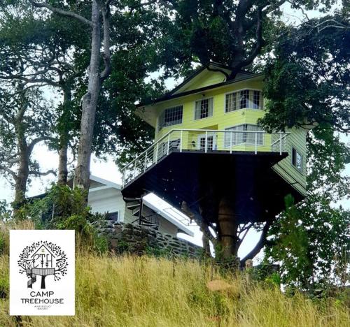 a large yellow house sitting on top of a hill at CAMP TREEHOUSE • COTTAGE • POOL • JACUZZI in Antipolo
