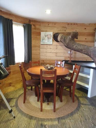 a dining room with a wooden table and chairs at CAMP TREEHOUSE • COTTAGE • POOL • JACUZZI in Antipolo