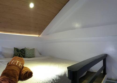 a bedroom with a bed with a wooden ceiling at CAMP TREEHOUSE • COTTAGE • POOL • JACUZZI in Antipolo