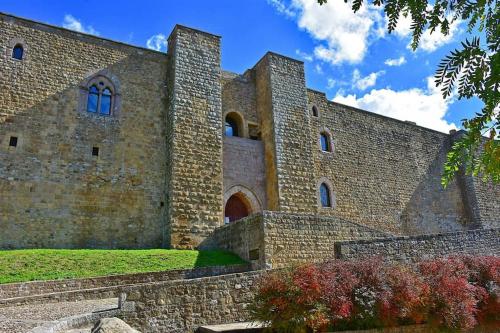 a large brick building with two towers on top at La Casa dei Nonni in Avigliano