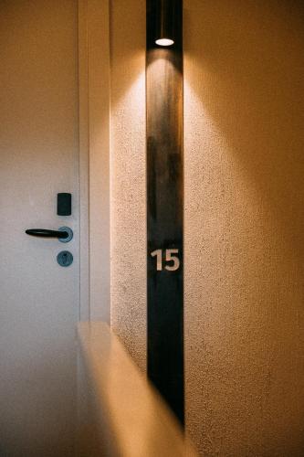 a clock on the wall next to a door at de Wever Lodge in Otterlo