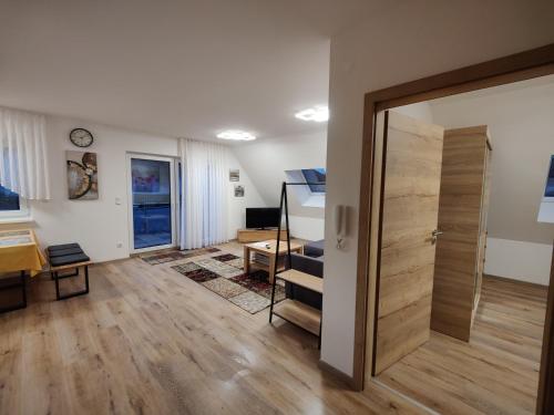 a living room with a sliding door and a desk at Ferienwohnung Elisabeth 2 in Gunzenhausen
