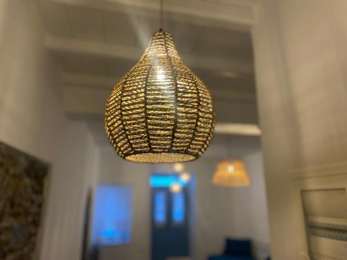 aendant light hanging from the ceiling in a room at BIANCO BLUE in Tinos Town