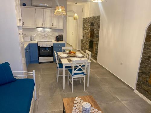 a kitchen and dining room with a table and chairs at BIANCO BLUE in Tinos Town