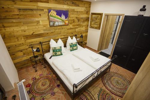 a bedroom with a bed with two pillows on it at Complex Butoaiele Transilvaniei - Cazare & SPA - Natura - Relaxare in Mediaş