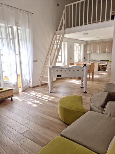 a living room with a ping pong table and a staircase at Il civico storico in Brindisi