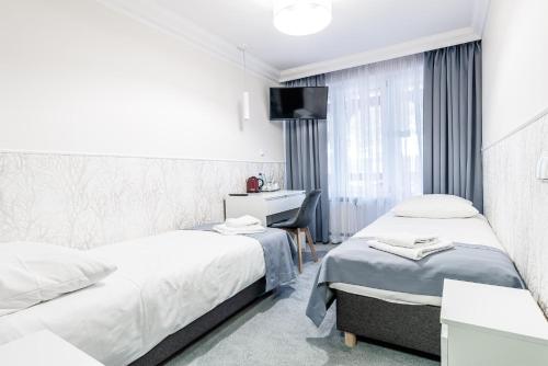 Voodi või voodid majutusasutuse Hotel Tajty toas