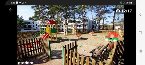 a picture of a playground with a fence at apartament MT burszynowe osiedle in Jantar