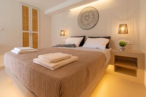 a bedroom with a bed with two towels on it at Aotés in Naxos Chora