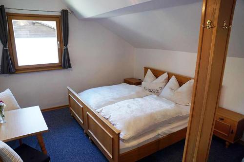 a bedroom with a bed and a window at Haus Alpenland in Mariazell