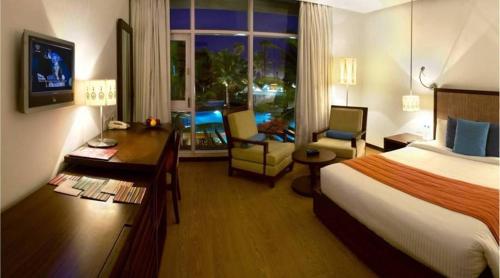 a hotel room with a bed and a desk and a room with a bed at The Park Visakhapatnam in Visakhapatnam