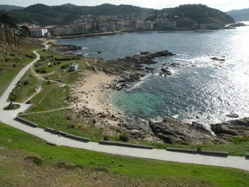 an aerial view of a beach and the ocean at Hotel Rompeolas in Baiona