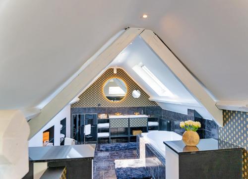 an attic room with a large window and a table at Gatsby River II in Yvoir