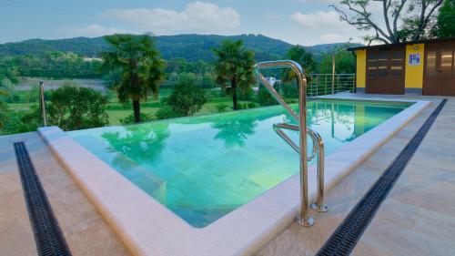 a swimming pool with a metal hand rail next to it at Casa Valla by Rent Istria in Buzet