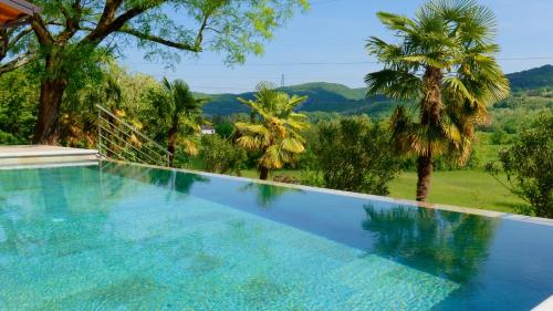 a swimming pool with a view of trees and mountains at Casa Valla by Rent Istria in Buzet