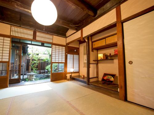 an empty room with a fireplace and a large glass door at naokonoza Bettei Umekoji in Kyoto
