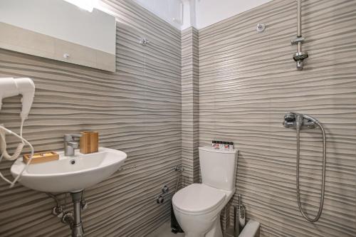 a bathroom with a toilet and a sink at Argo Boutique Hotel in Naxos Chora