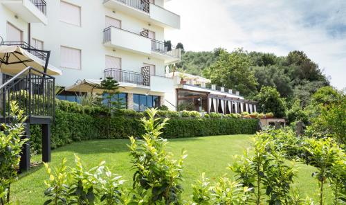 an exterior view of a building with a yard at Doria Park Hotel in Lerici