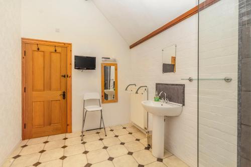 a bathroom with a sink and a shower at Southport Coach House in Southport