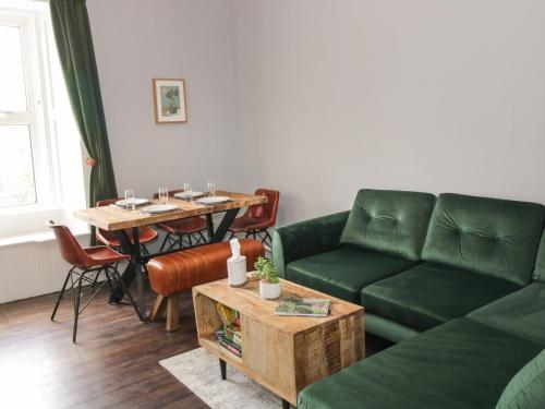a living room with a couch and a table at 40 Main Street in Burntisland