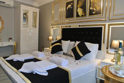 a bedroom with a large bed with towels on it at Emirhan Guesthouse & Suites in Istanbul